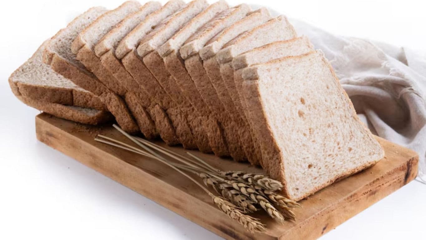 Sliced whole wheat bread on wooden board