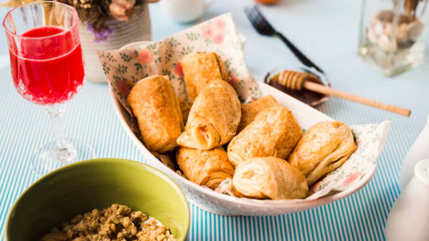 Breakfast table with pastries and red juice