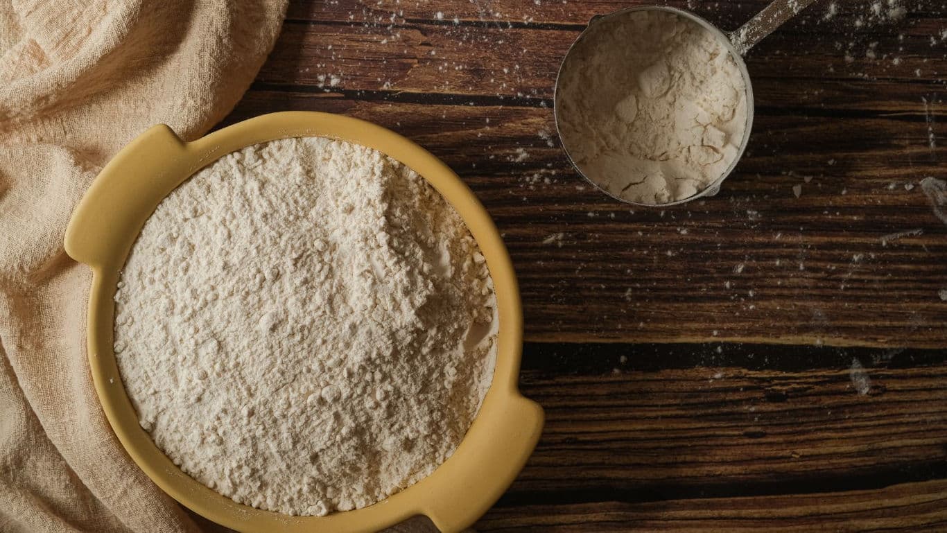 Bowl of Flour on Rustic Wooden Table