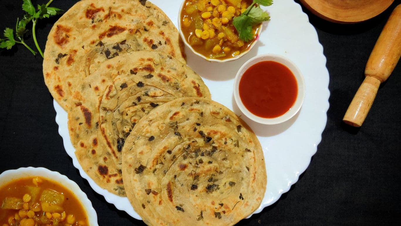 Indian stuffed paratha with chutney and curry