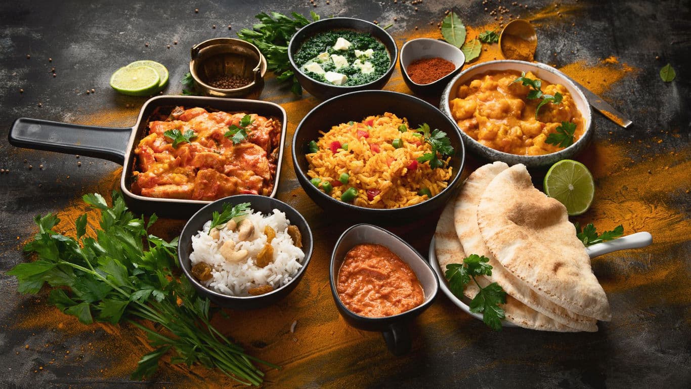 Assorted Indian Dishes with Rice and Naan Bread