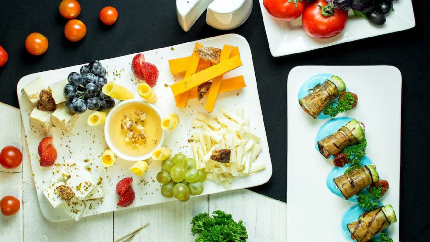 Assorted cheese platter with fresh vegetables