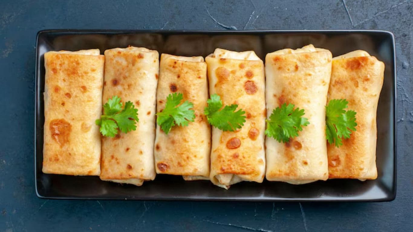 Golden brown stuffed crepes garnished with cilantro