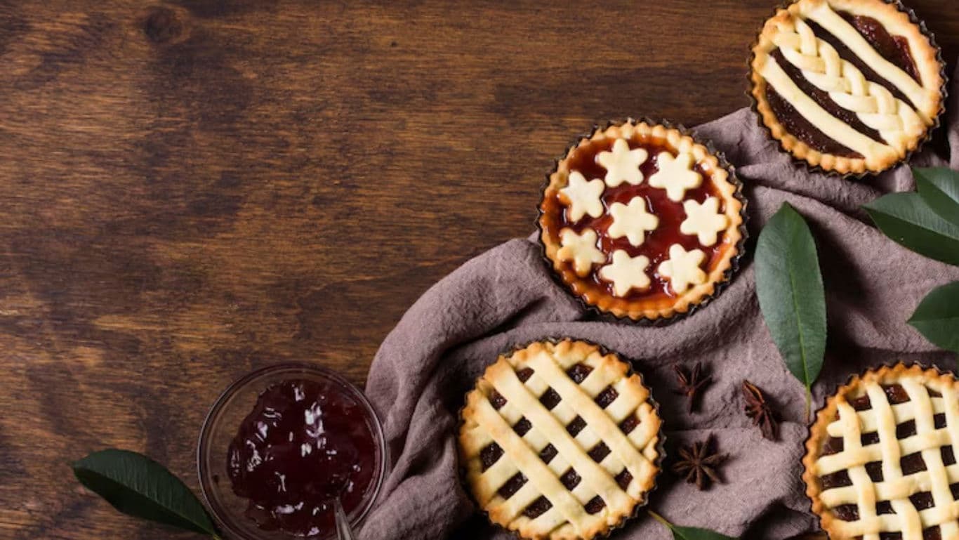 Assorted Mini Fruit Pies on Rustic Wooden Table