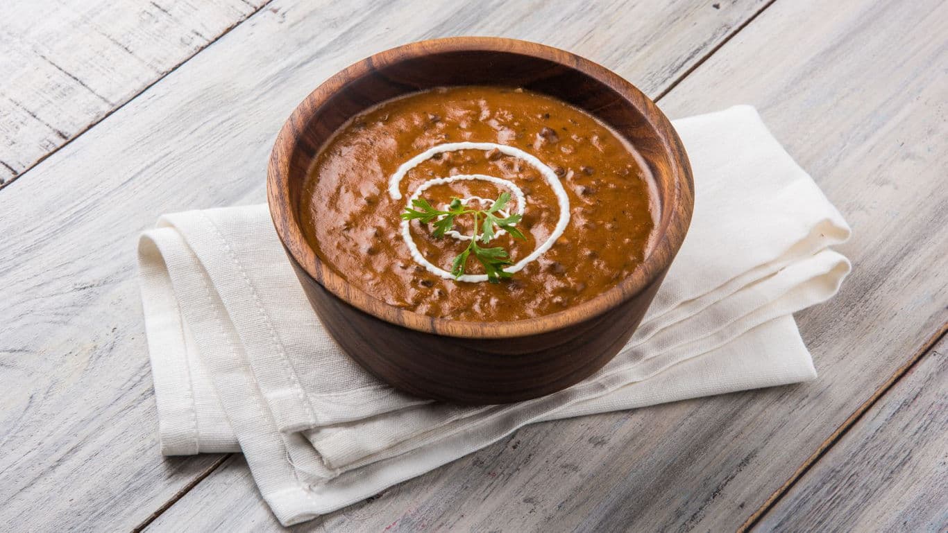 Wooden bowl of creamy lentil curry
