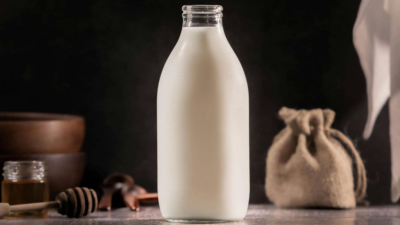 Glass Bottle Of Milk On Rustic Table