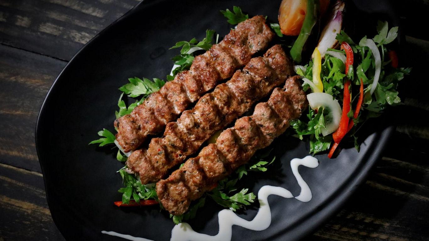 Grilled kebabs with fresh salad garnish