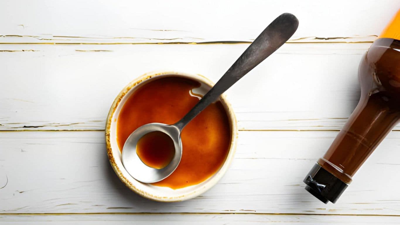 Bowl of Brown Sauce with Metal Ladle Overhead