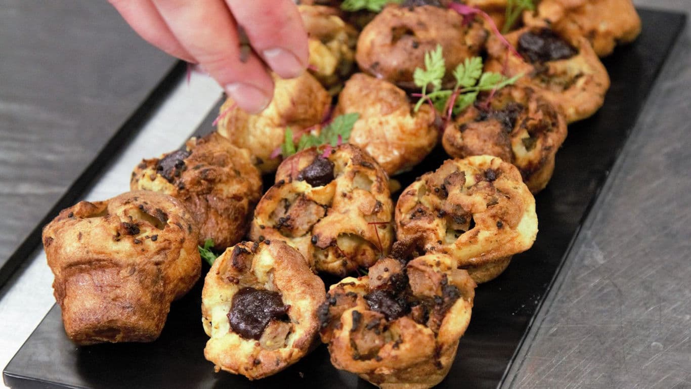 Chef Garnishing Savory Bite-Sized Muffins