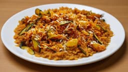 Zucchini and carrot thoran on a white plate