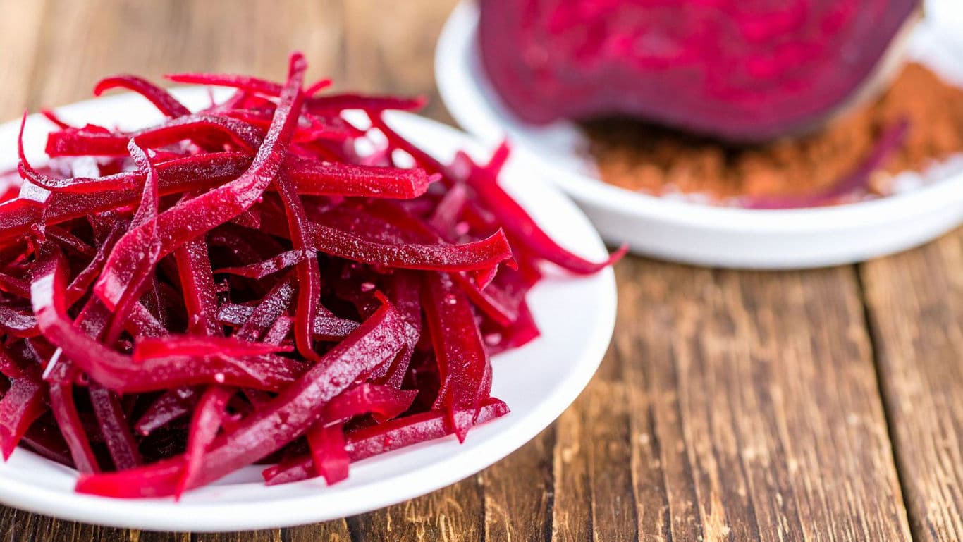 Freshly Shredded Beetroot on White Plate