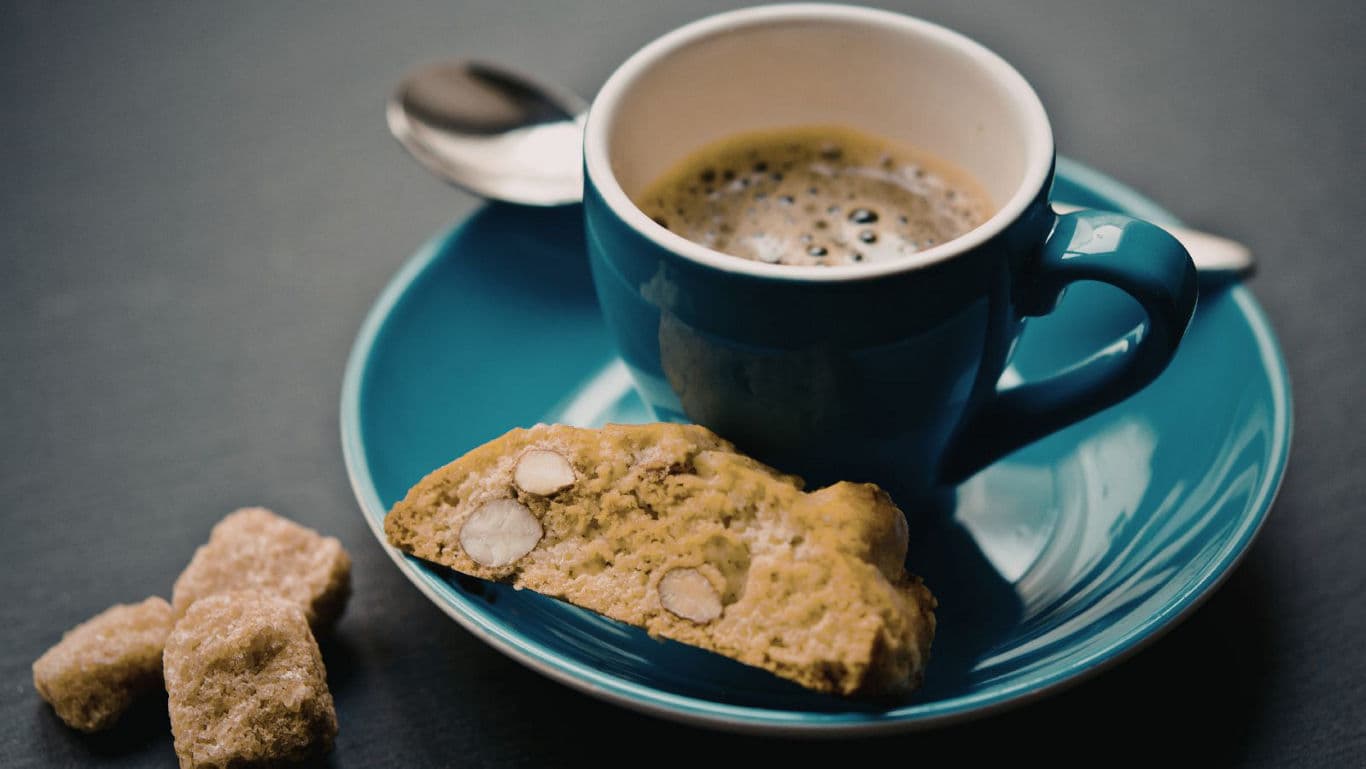 Espresso in blue cup with biscotti
