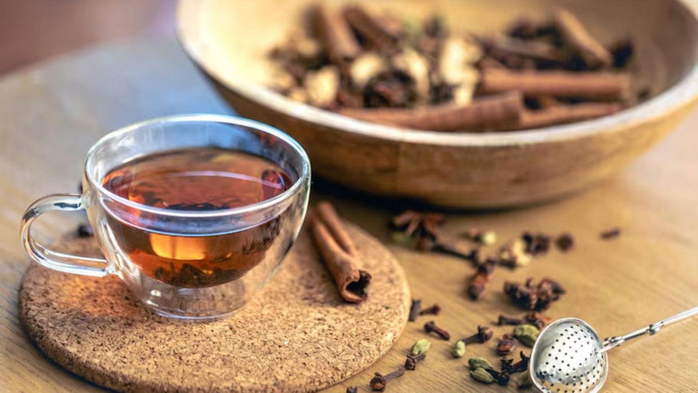 Glass cup of spiced tea with cinnamon
