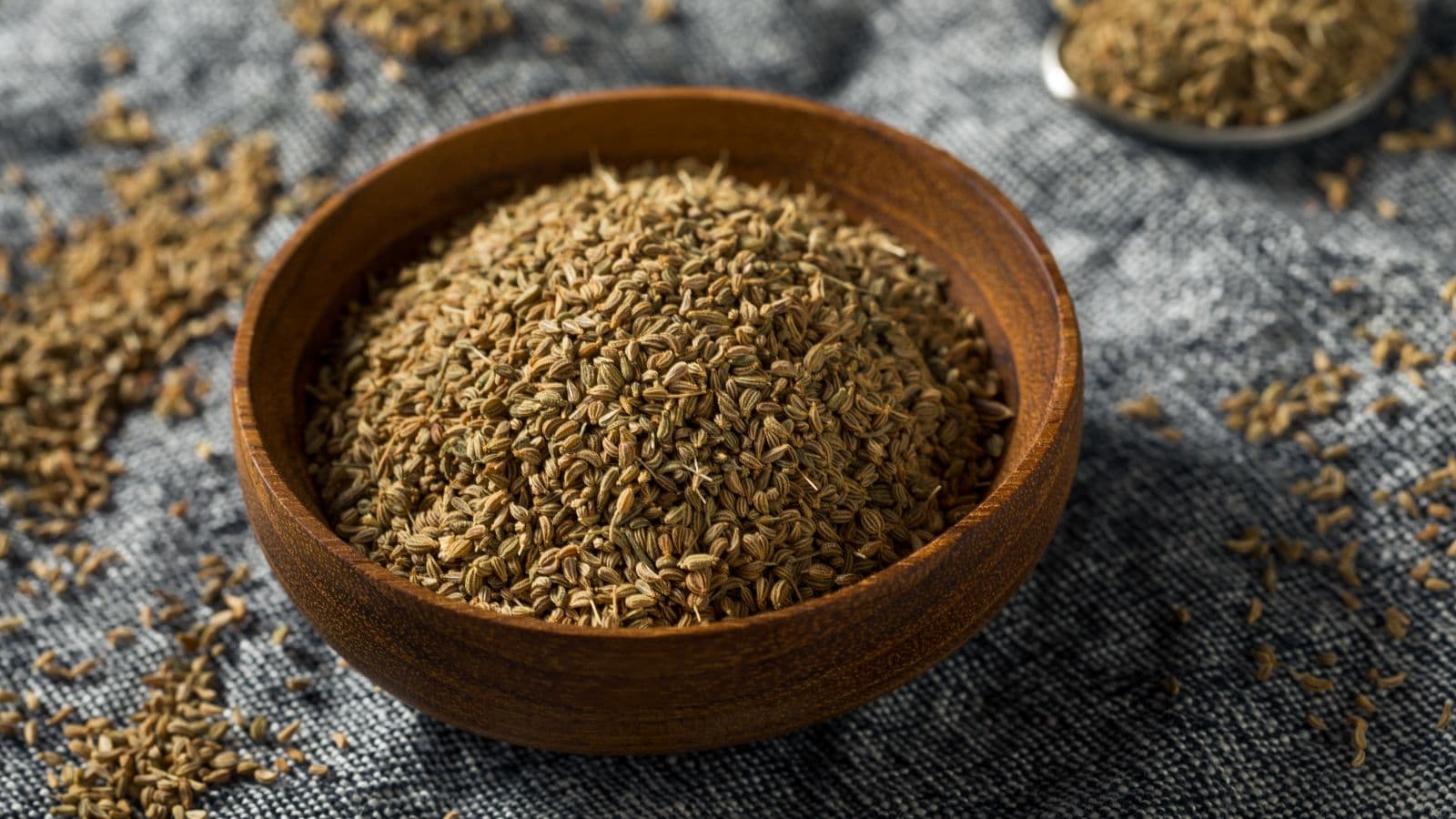 Wooden bowl of dried ajwain seeds