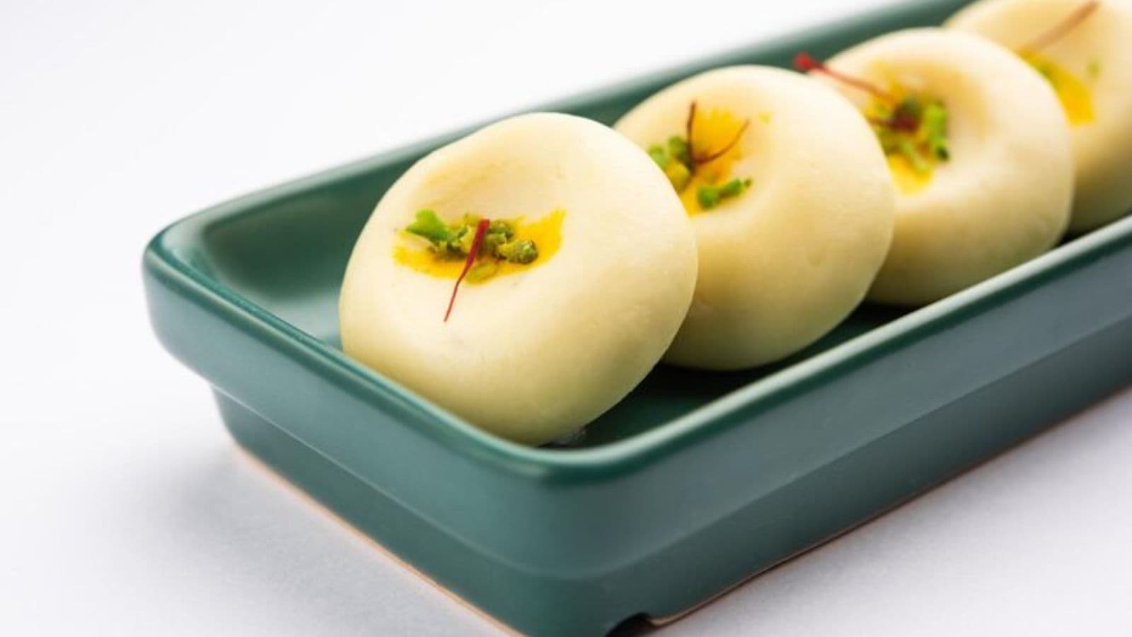 Traditional sweets served in green ceramic tray