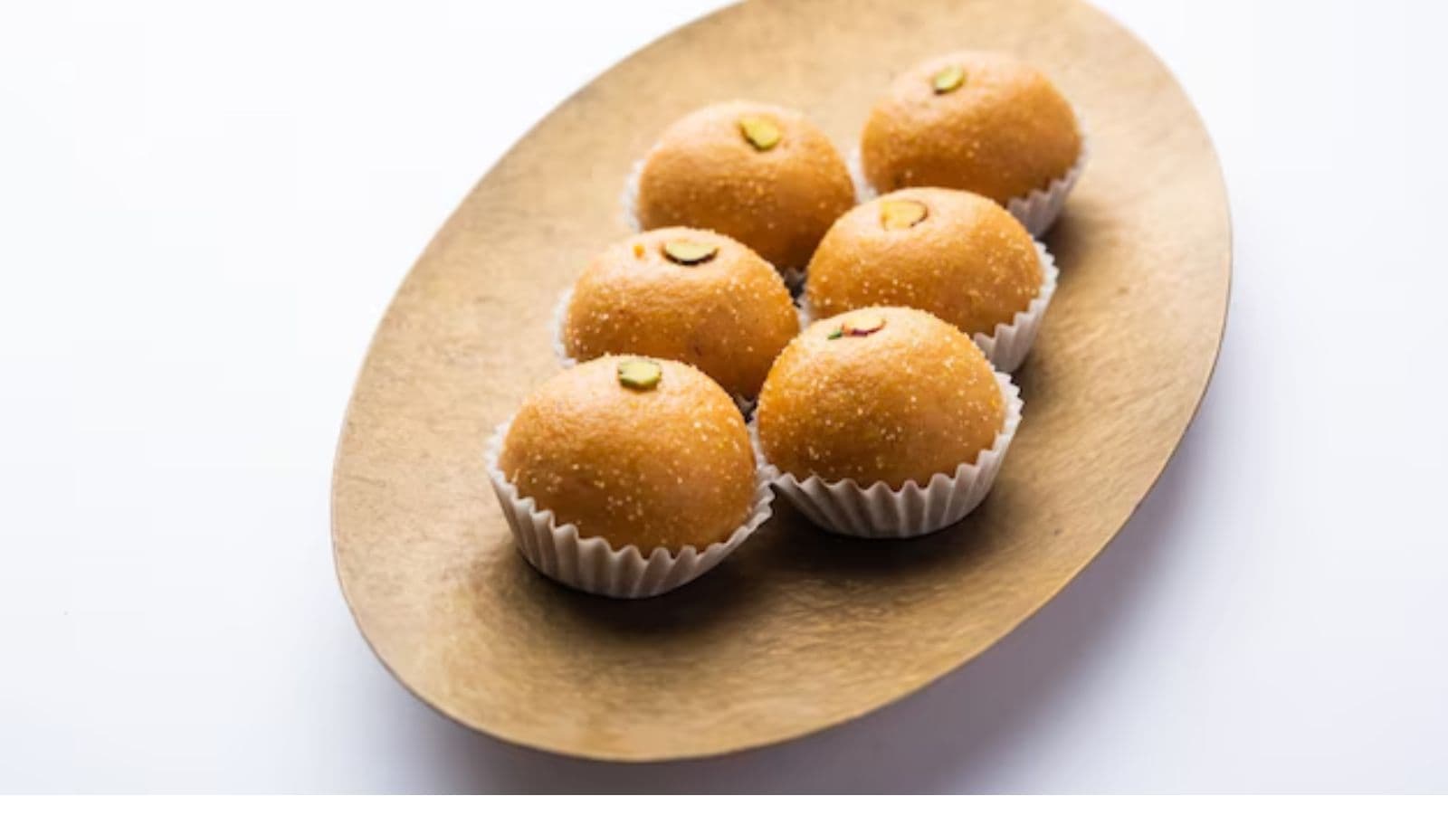 Golden Indian sweets on oval platter
