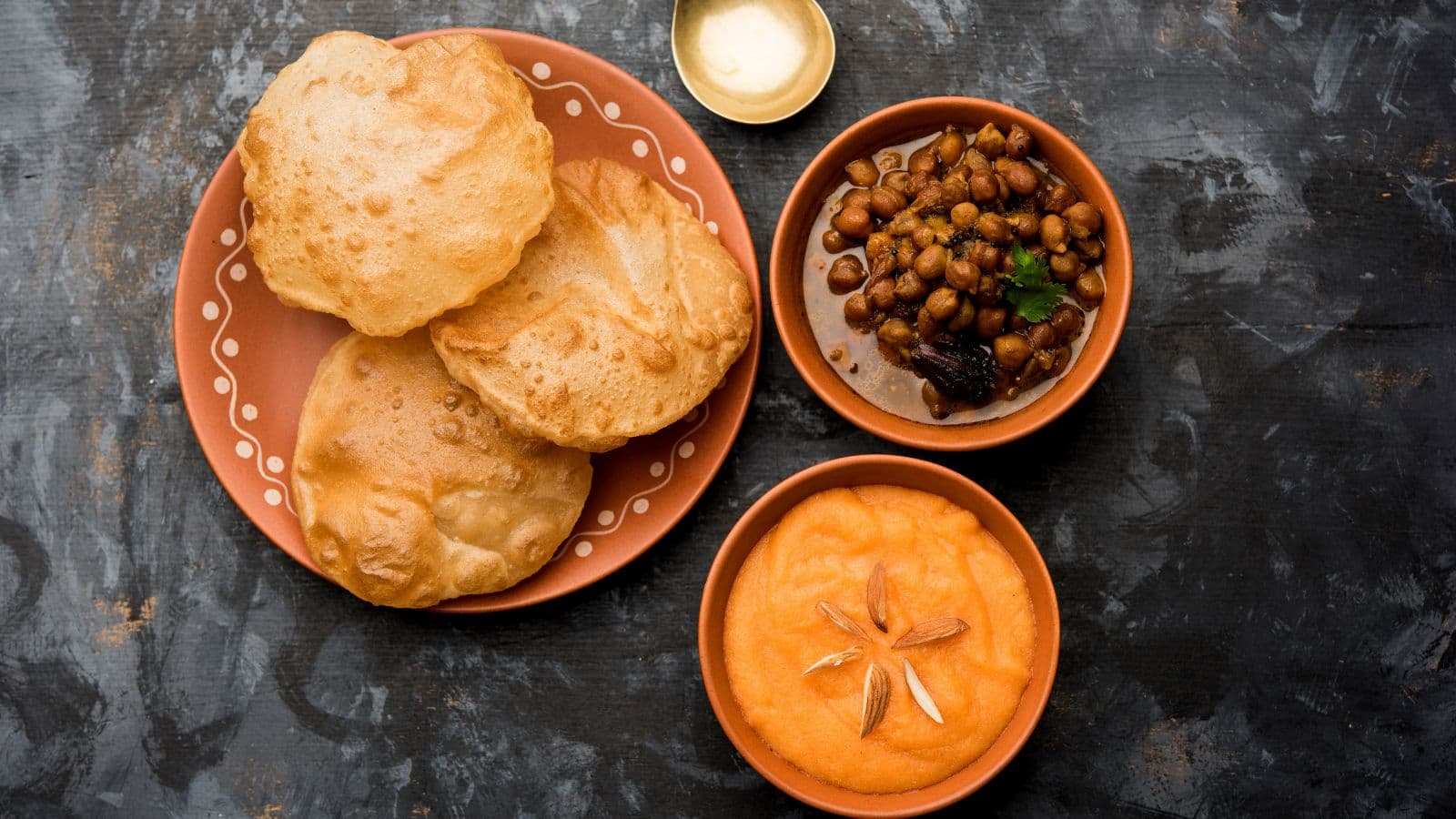 halwa, poori, chana dishes arranged for puja.